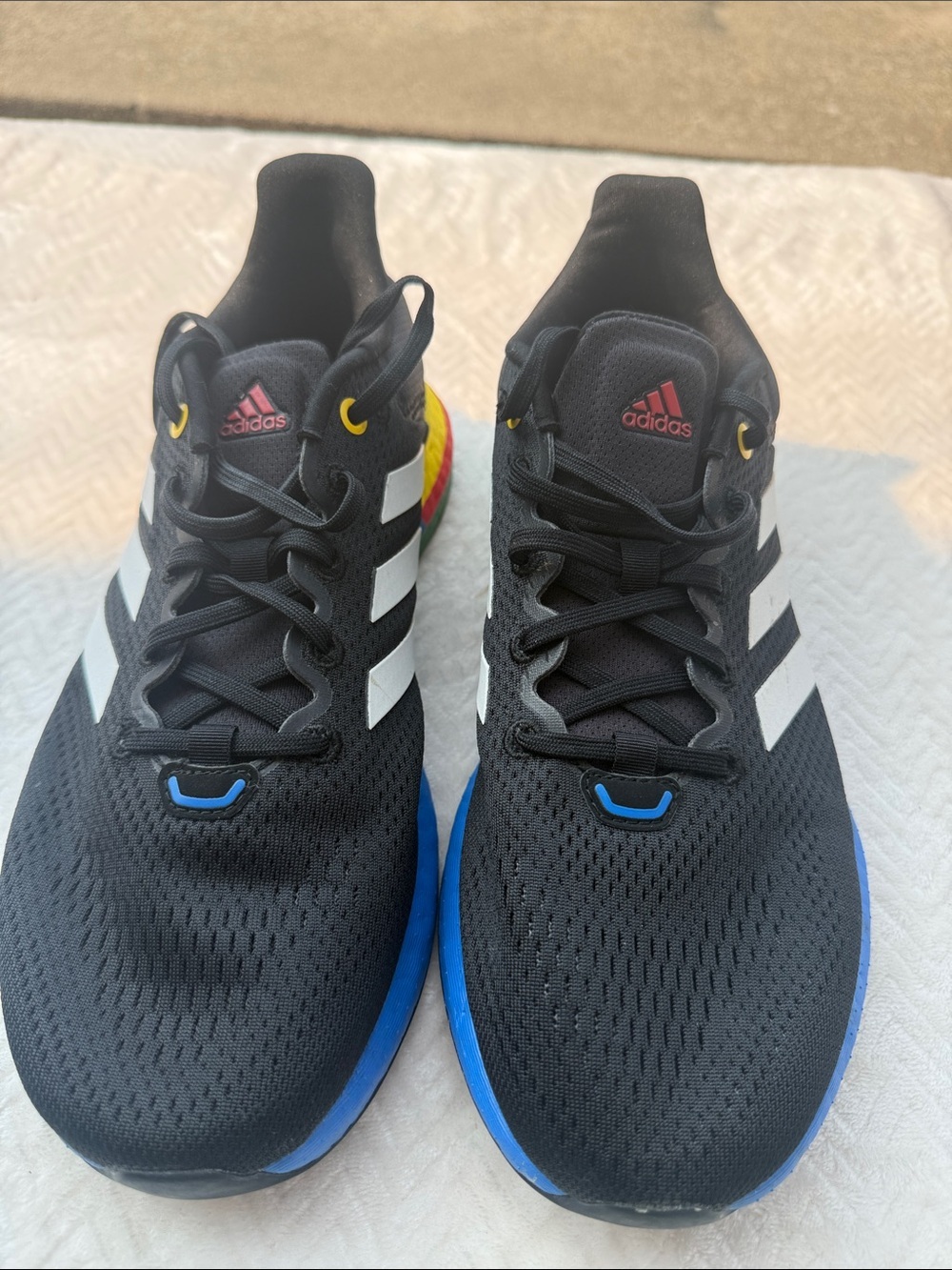Adidas  Black Athletic Shoes with White Stripes and Blue & Yellow Accents Size 9